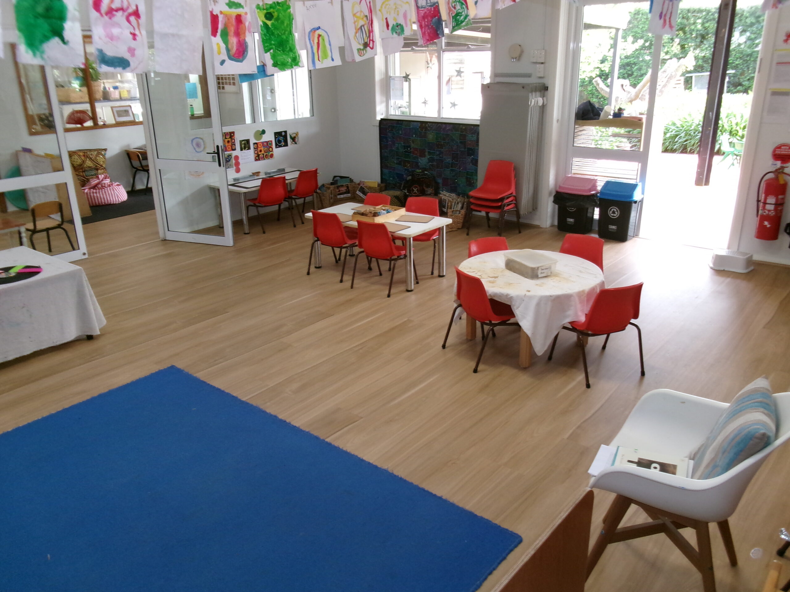 Our preschool classroom with activity tables and children’s artwork